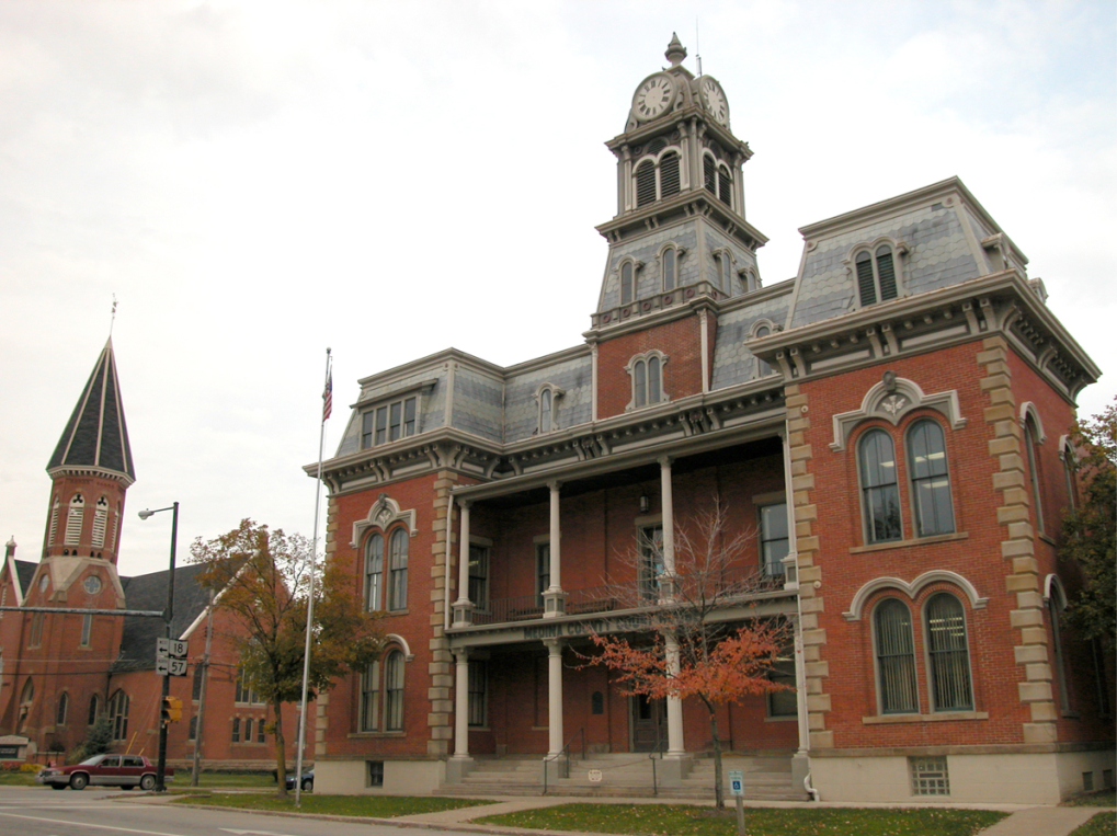 side view of the Medina County Courthouse, a brick Victorian building with a tower copula on front, the located near homes for sale in Medina Ohio