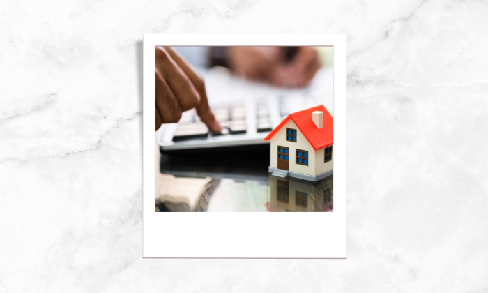 A photo of an individual computing the house price.