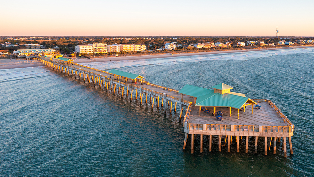 arial view of folly beach pier at sunset