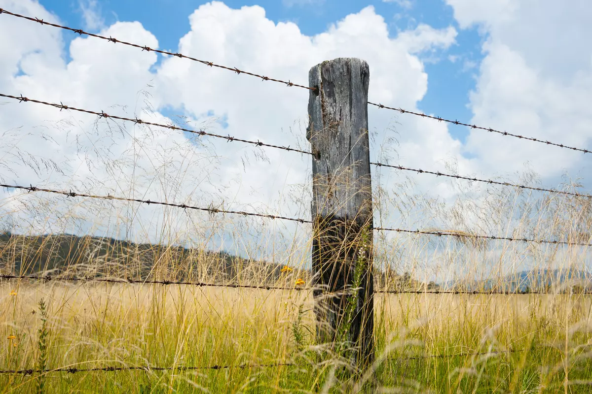 A fenced property in Texas overlooking the sprawling landscape.