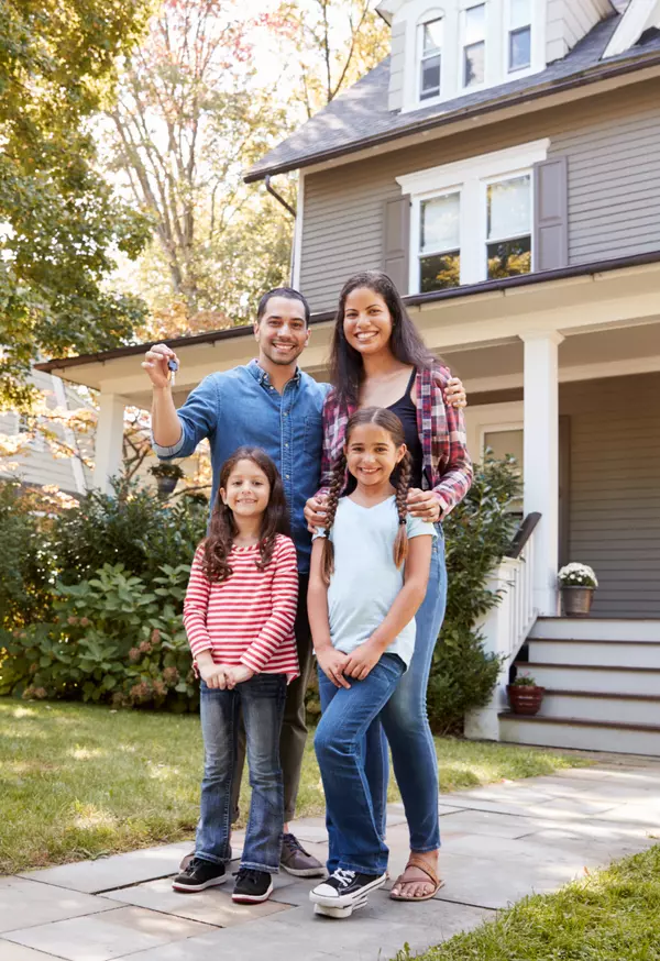 portrait-of-family-holding-keys-to-new-home-on-mov-2021-08-26-16-13-42-utc