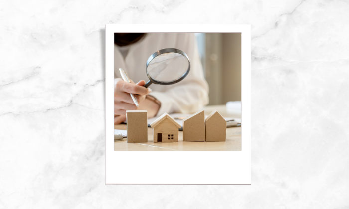 A photo of an individual assessing a house's value