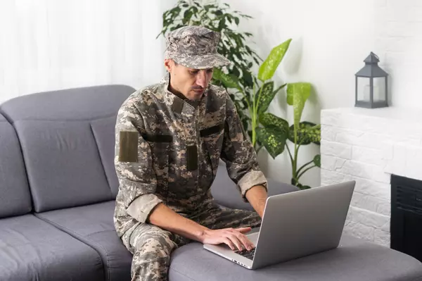 military-man-in-uniform-looking-at-laptop-2023-02-22-20-49-58-utc