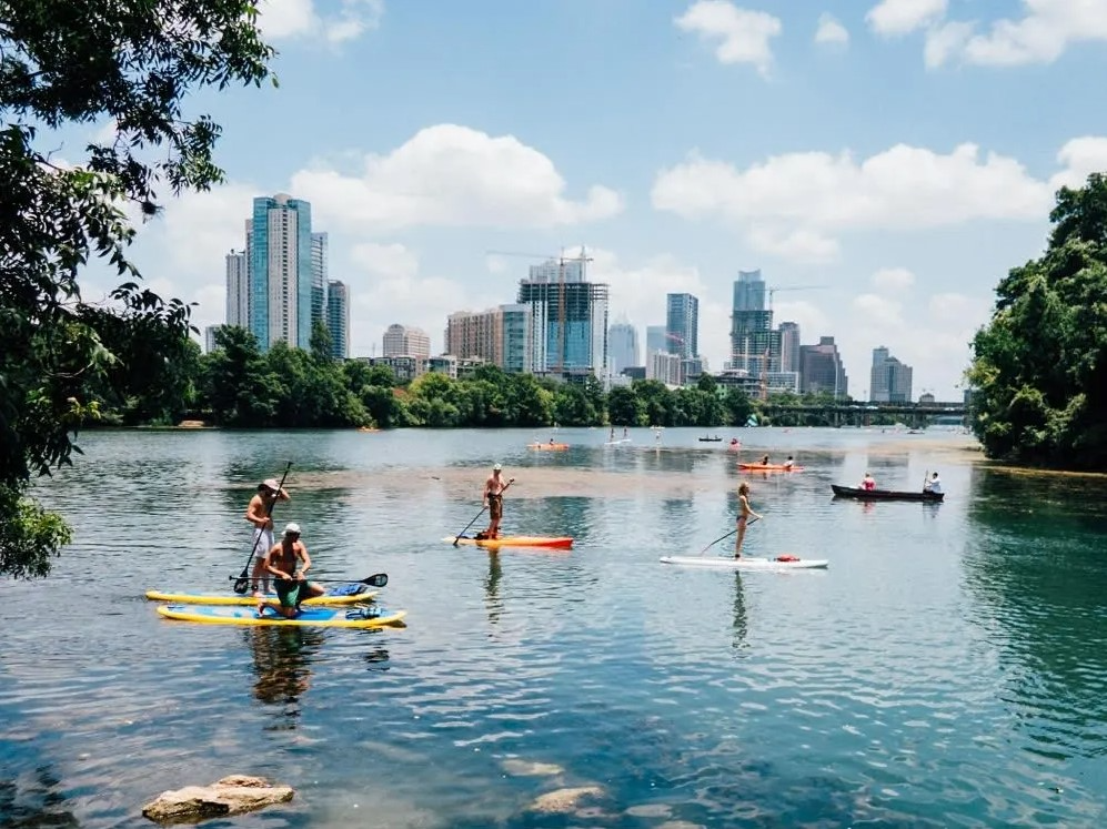 people paddle boarding on lake austin