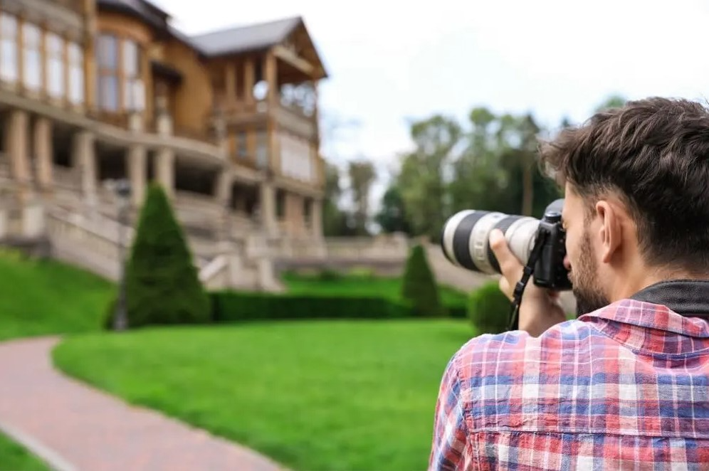 realtor taking photo of house