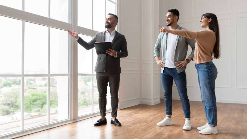 Miami realtor discussing property details with potential buyers, illustrating the personal guidance and expert advice offered during the home buying process.