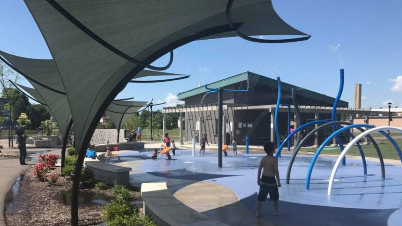 View of children playing at the City of Green splash park located near homes for sale in Green Ohio