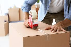 Moving boxes in a living room, labeled and ready for a successful move to a new Miami home.