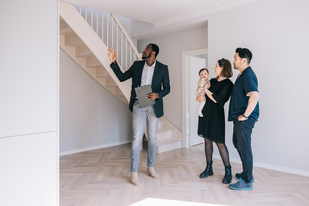 Family at open house getting tour from real estate agent