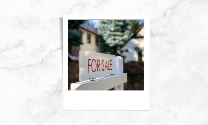 A photo of a sign that shows house for sale