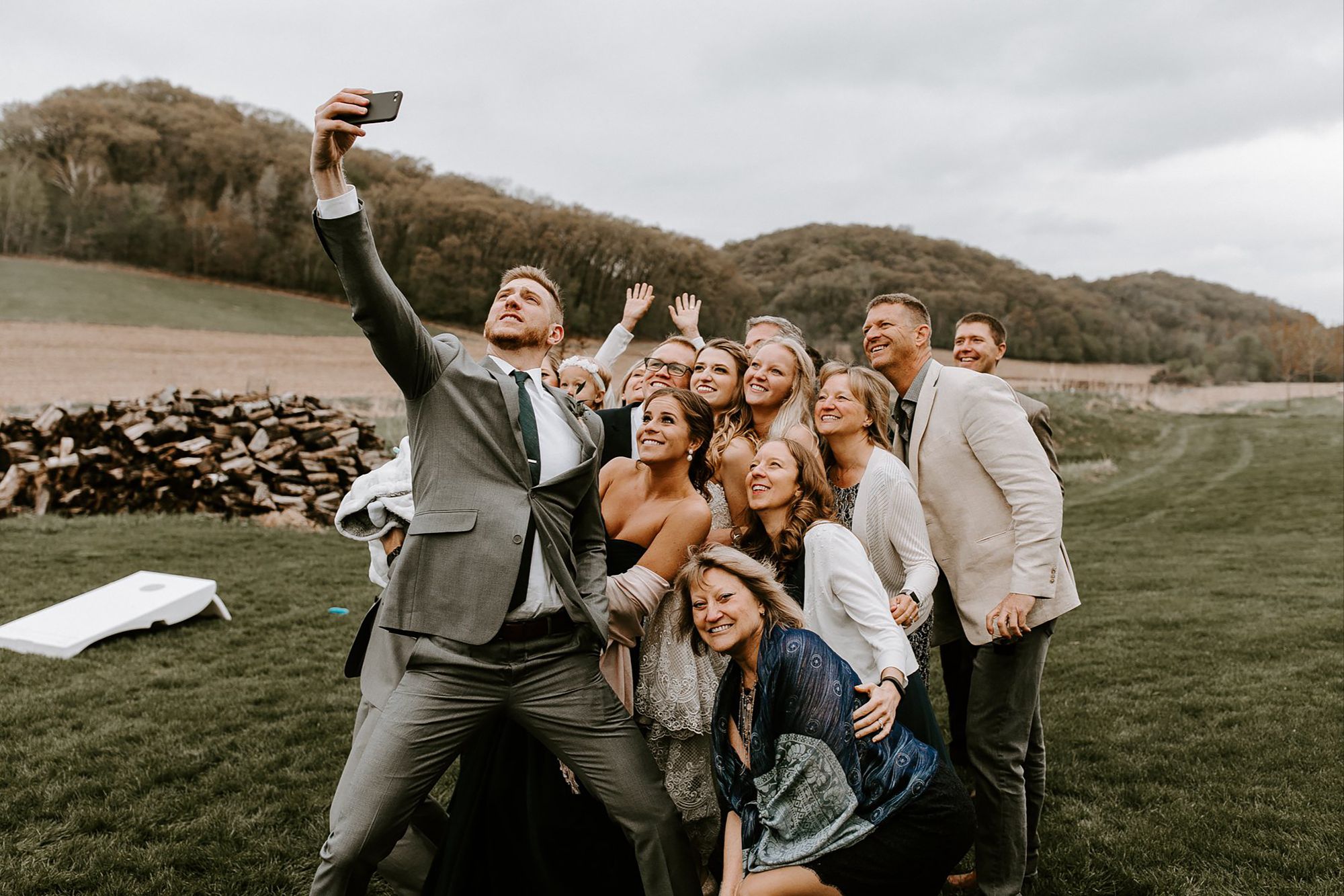 A group of people standing next to a body of waterDescription automatically generated