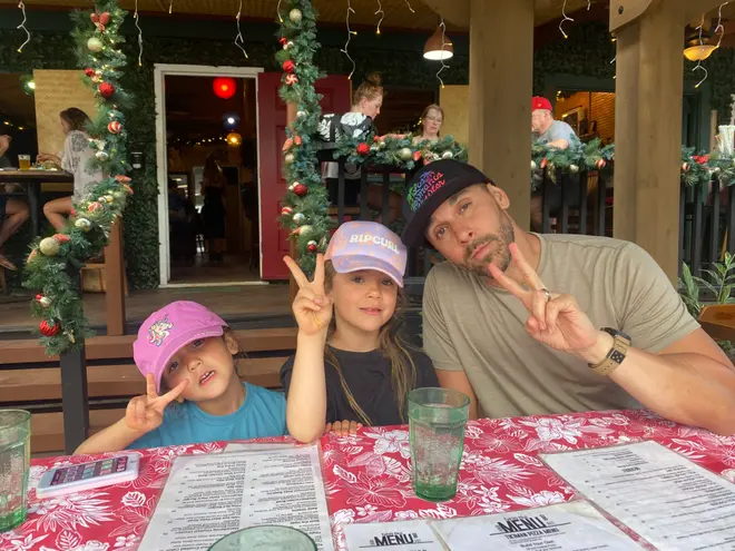 Anthony Gibson with his daughters at a restaurant