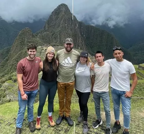 Brittany Wenninger and her husband Clay Wenninger, standing in awe at the majestic Machu Picchu, a bucket-list destination.