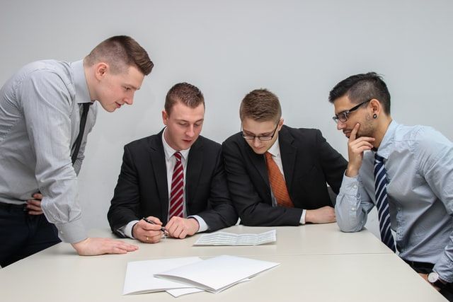 A home buyer with his team analyzing the home-buying contract