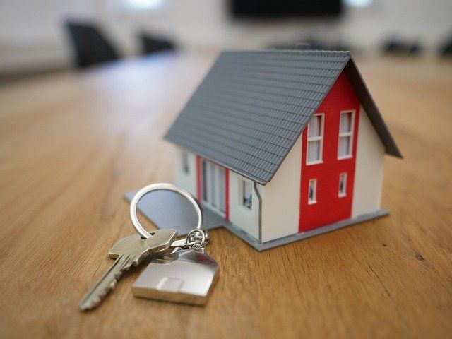 A miniature model of a house, with a set of keys next to it