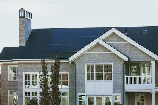 solar panels on the roof of a large house