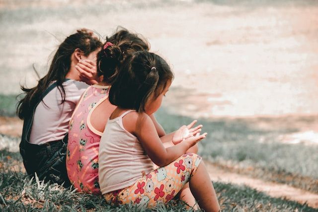 three girls sitting next to each other