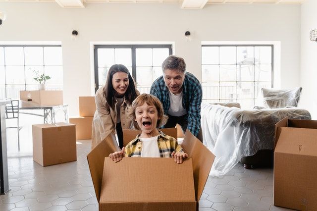 A couple holding boxes in their hands.