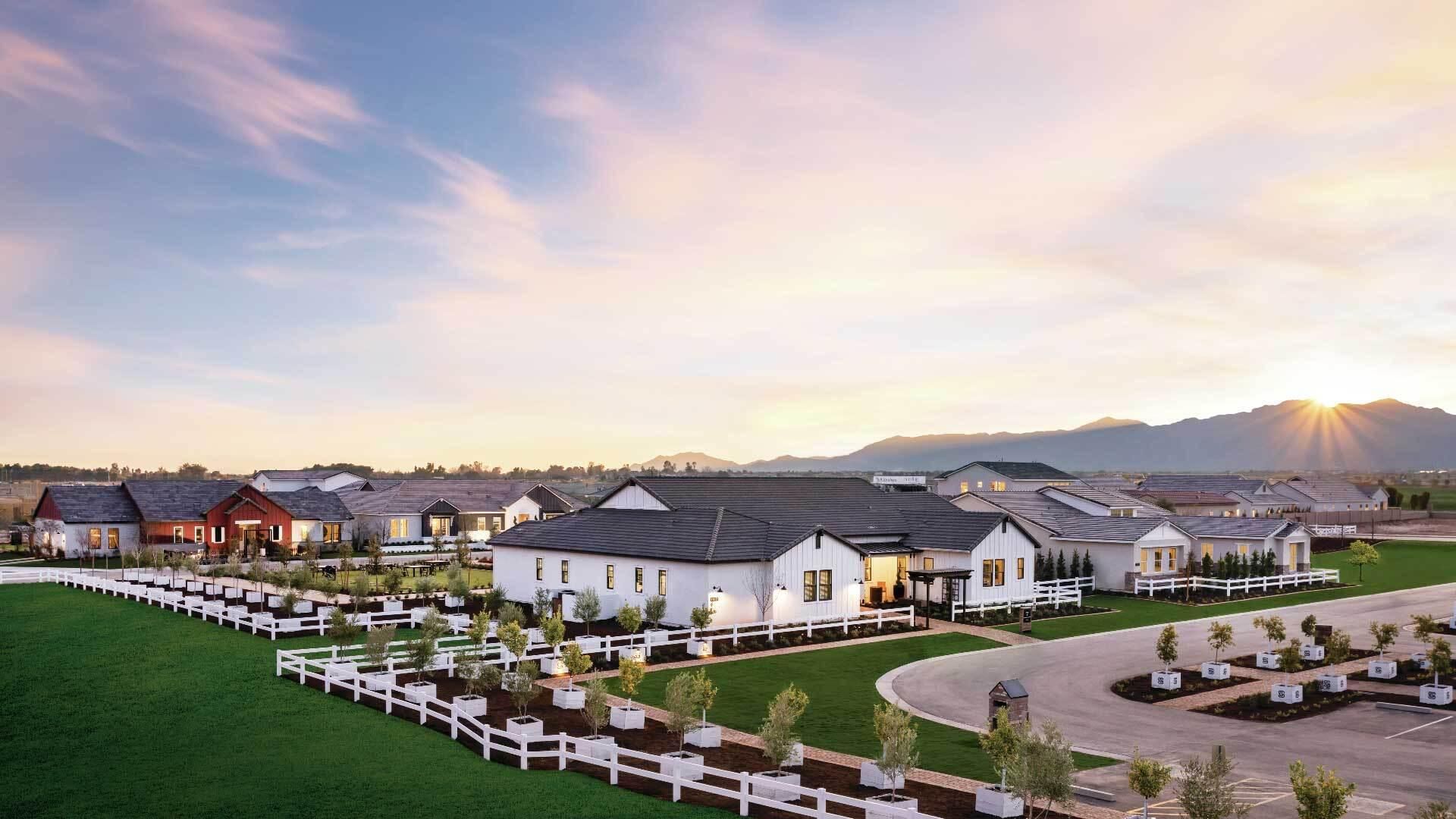 New construction homes in a master-planned community at sunrise, featuring modern farm-style architecture with landscaped yards and mountain views – highlights the importance of having real estate agent representation to be informed, guided through the process, and make the best decision both as an investment and a home.