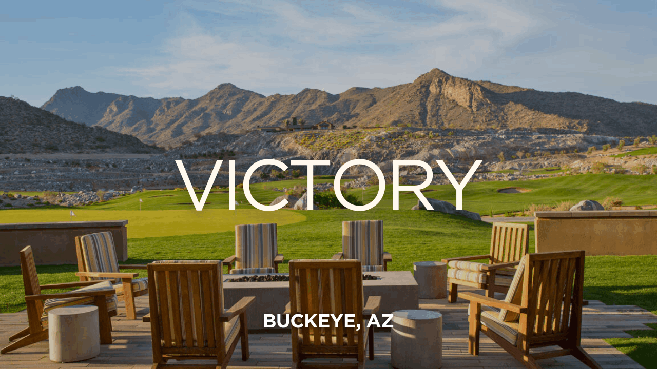 Outdoor seating area with mountain views at Victory at Verrado in Buckeye, Arizona, showcasing scenic desert landscapes, a well-manicured golf course, and luxurious amenities perfect for active adult living.