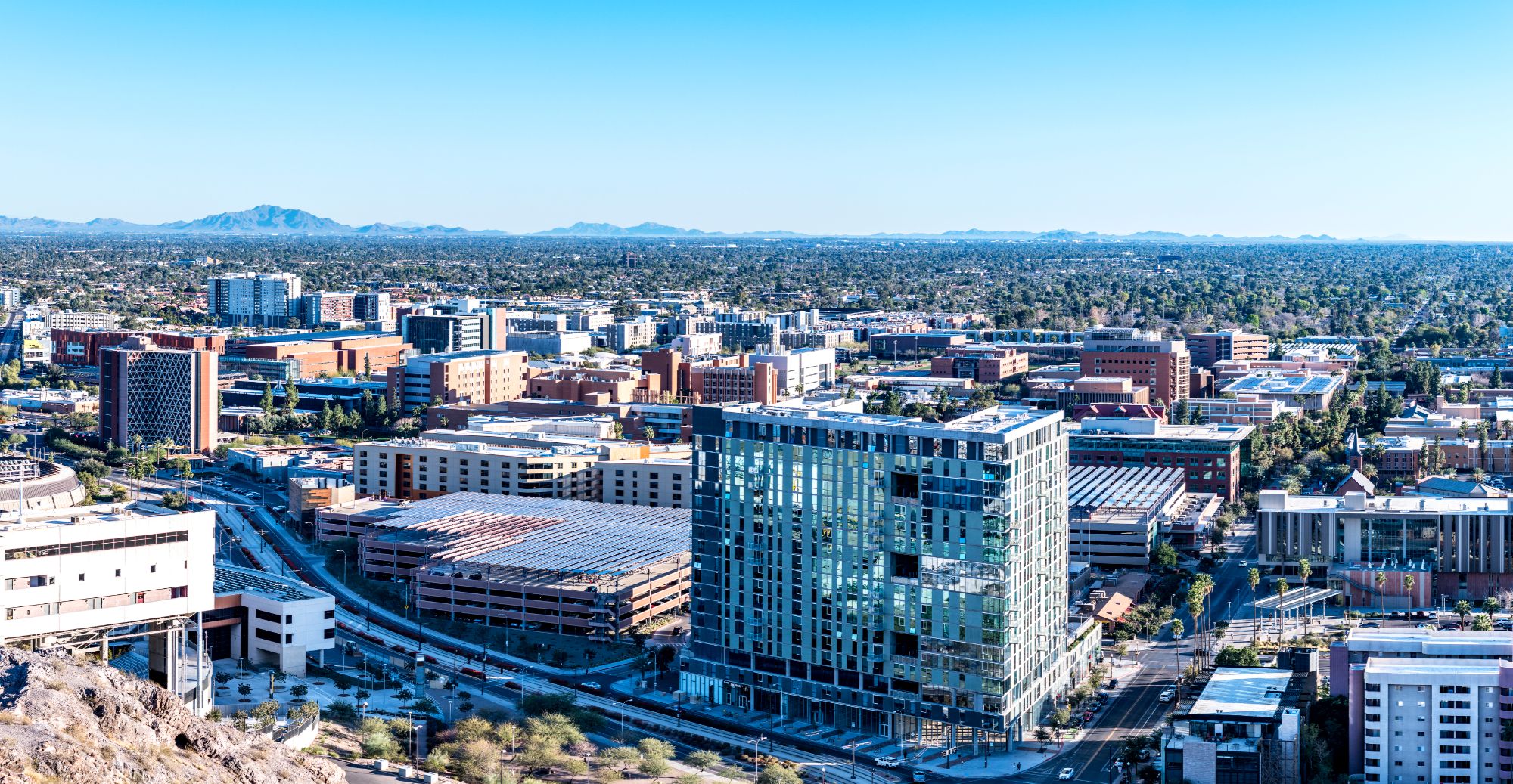 Aerial view of Tempe, Arizona, highlighting its modern cityscape and proximity to spring training facilities, making it a prime destination for baseball fans. The city's vibrant urban environment, scenic desert backdrop, and numerous amenities create the perfect setting for spring training activities and tourism.