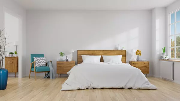 Scandinavian interior of bedroom concept design,blue lounge chair with wood bedside table and white bed on white wall