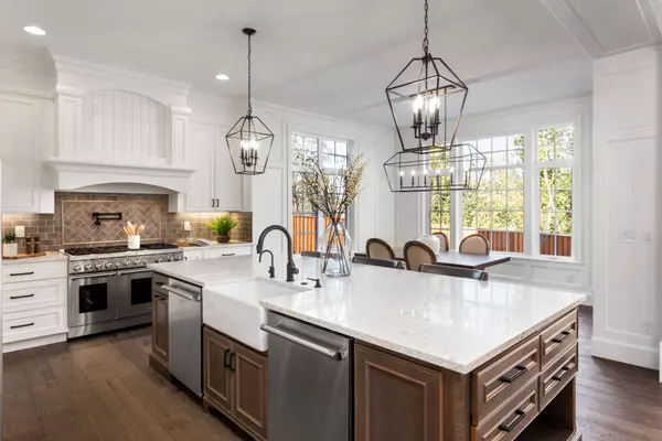 Beautiful kitchen in new traditional style luxury home, with quartz counters, hardwood floors, and stainless steel appliances