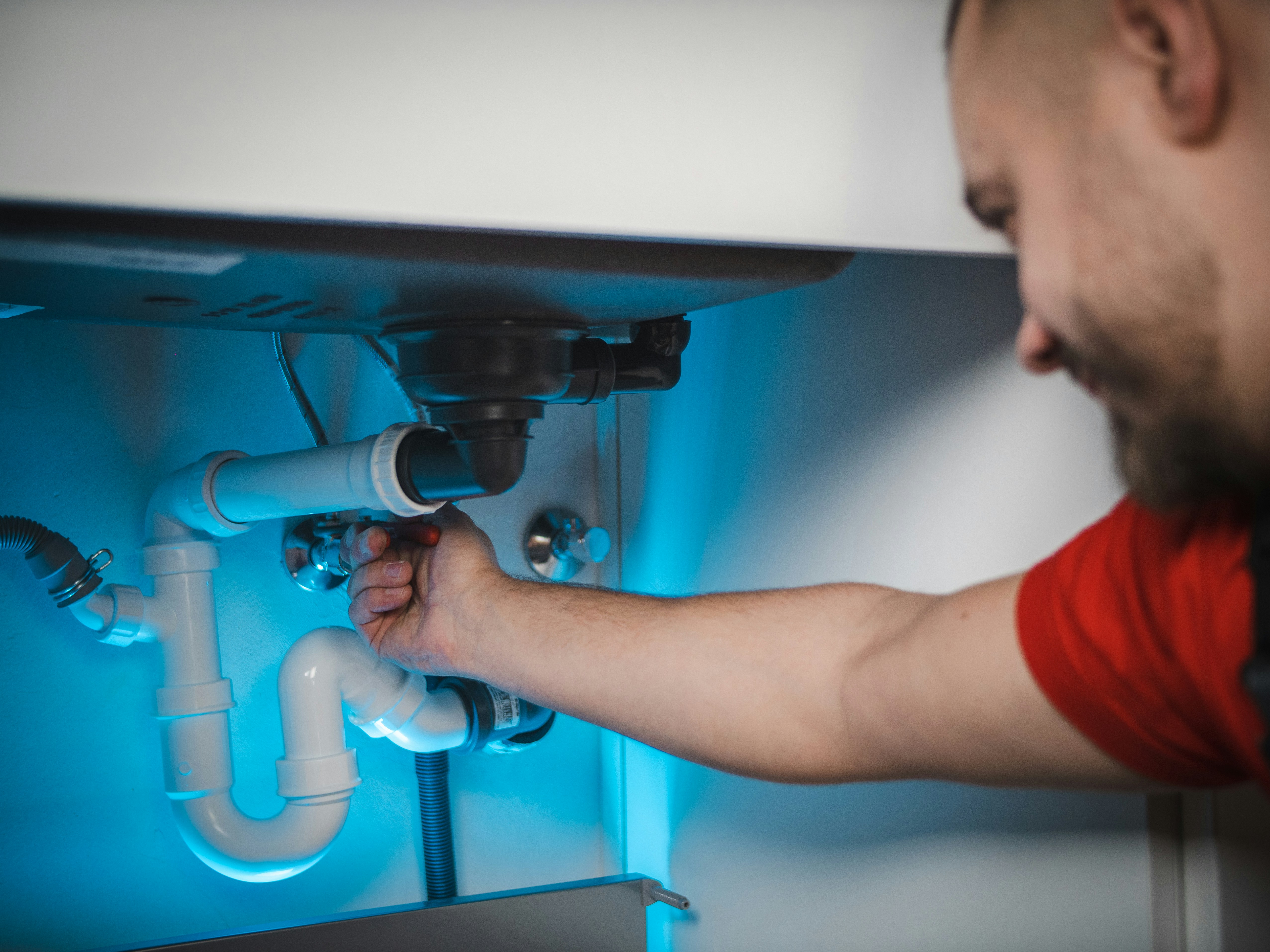 A plumbing professional checking the pipes to make sure they are working properly