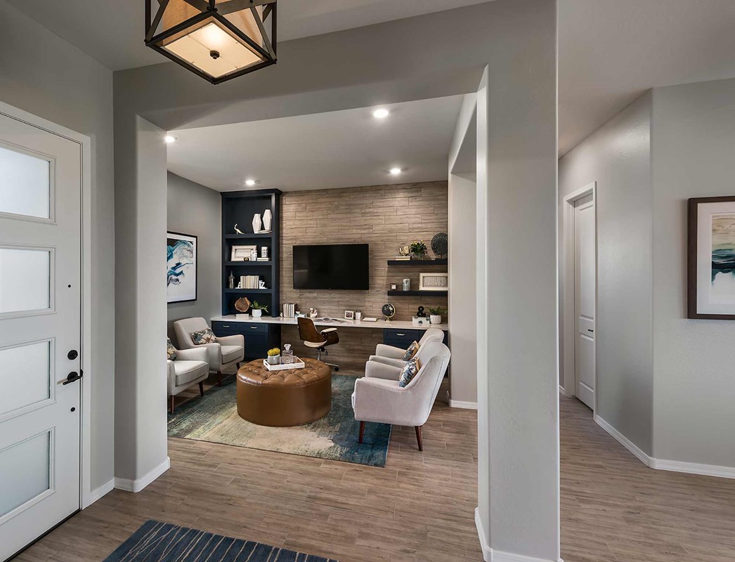 Modern home office space in Arizona with stylish decor, comfortable seating, and natural lighting, exemplifying ideal remote work opportunities in Arizona homes, which offer spacious, well-designed environments for productivity and work-life balance.