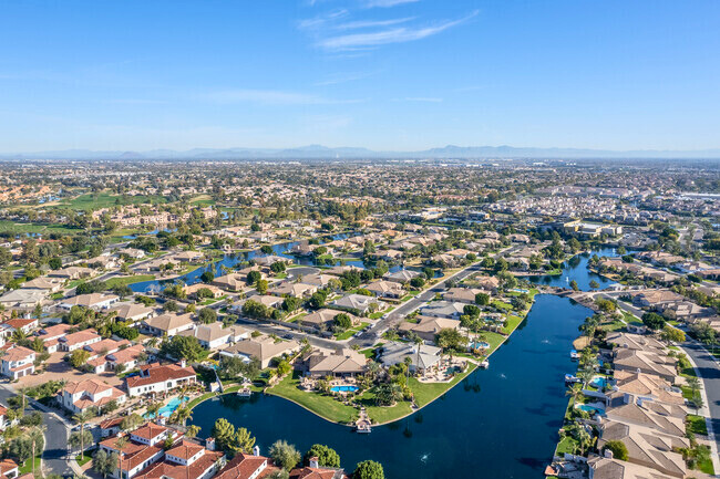 Arial view of Ocotillo neighborhood in Chandler, AZ, showcasing scenic waterfront homes, lush green spaces, and a network of lakes, highlighting the desirable living environment and resort-like amenities in one of Chandler's most popular communities.