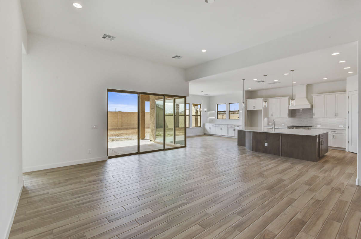 Spacious Gourmet Kitchen in New Construction Home in Litchfield Park, AZ - Featuring Upgraded Cabinets, Custom Countertops, Gas Cooktop, and Stylish Backsplash