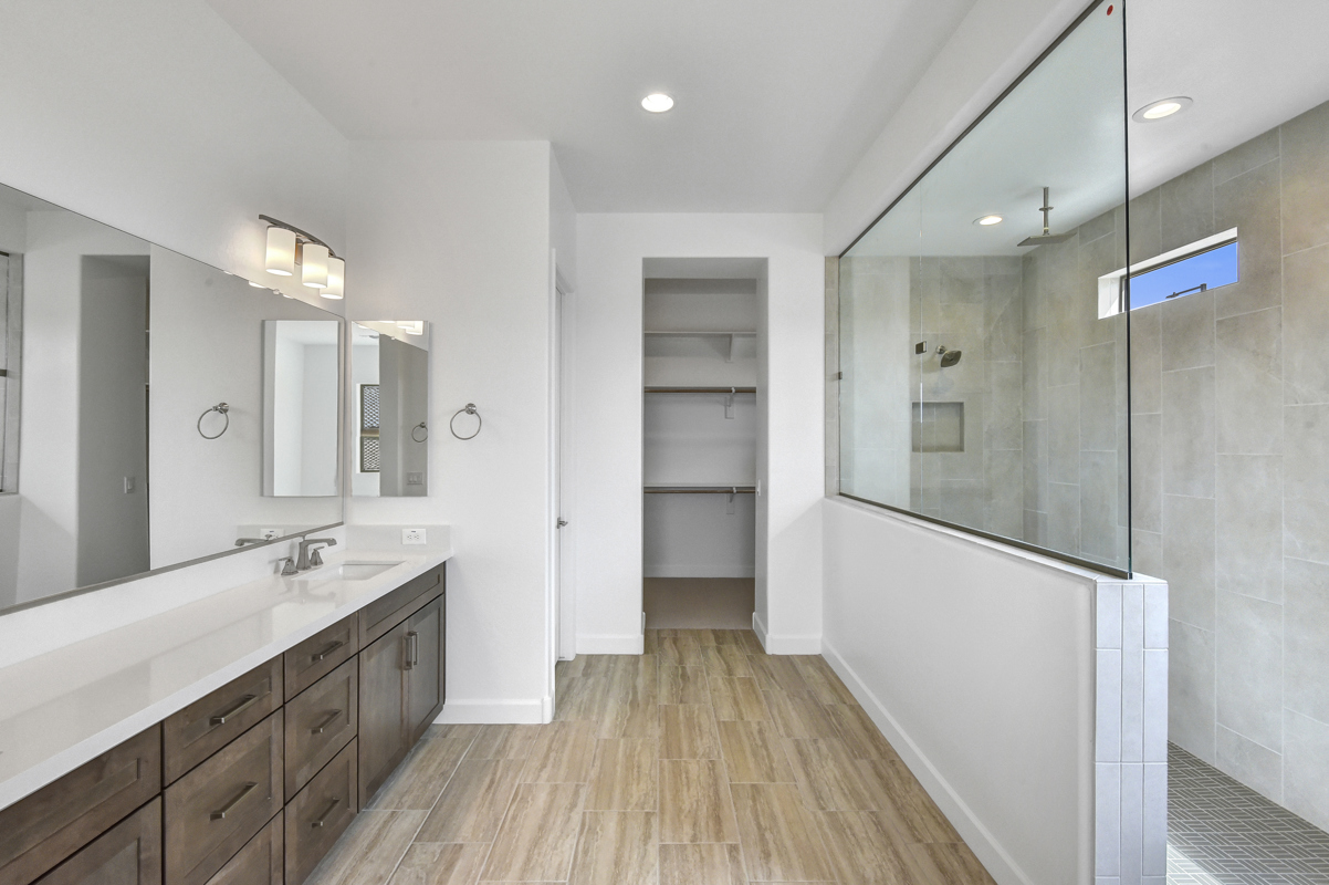 Luxurious Owner's Retreat Bathroom in New Construction Home in Litchfield Park, AZ - Featuring Spacious Walk-In Shower, Double Vanity, and Elegant Premium Finishes