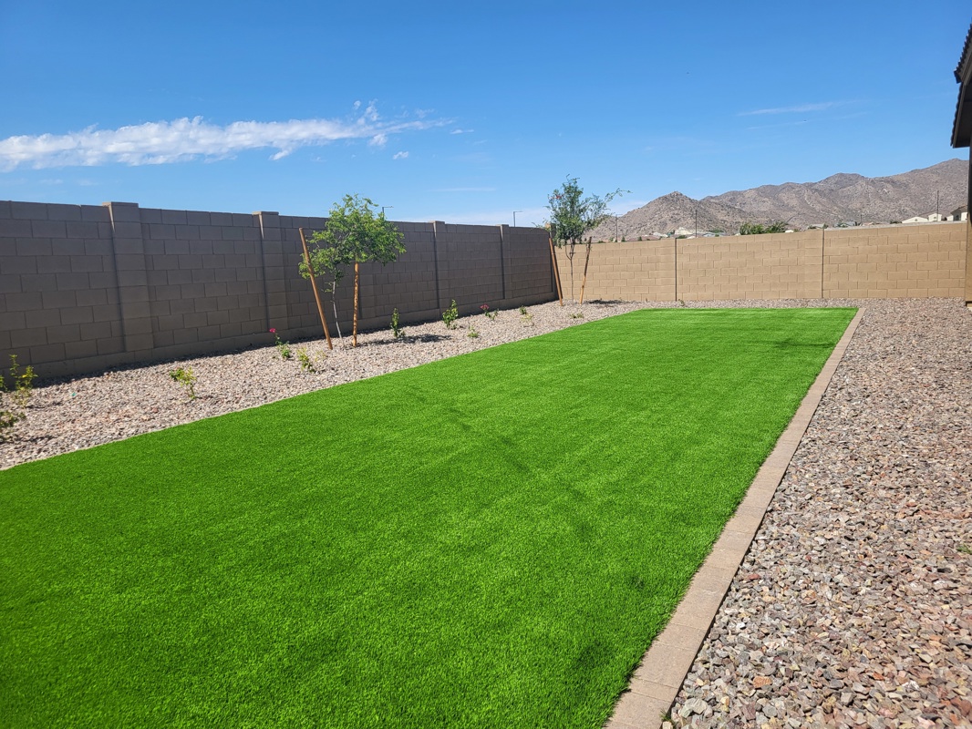 Beautifully Landscaped Backyard with Artificial Turf and Mountain Views in New Construction Home in Litchfield Park, AZ - Perfect for Outdoor Living and Relaxation