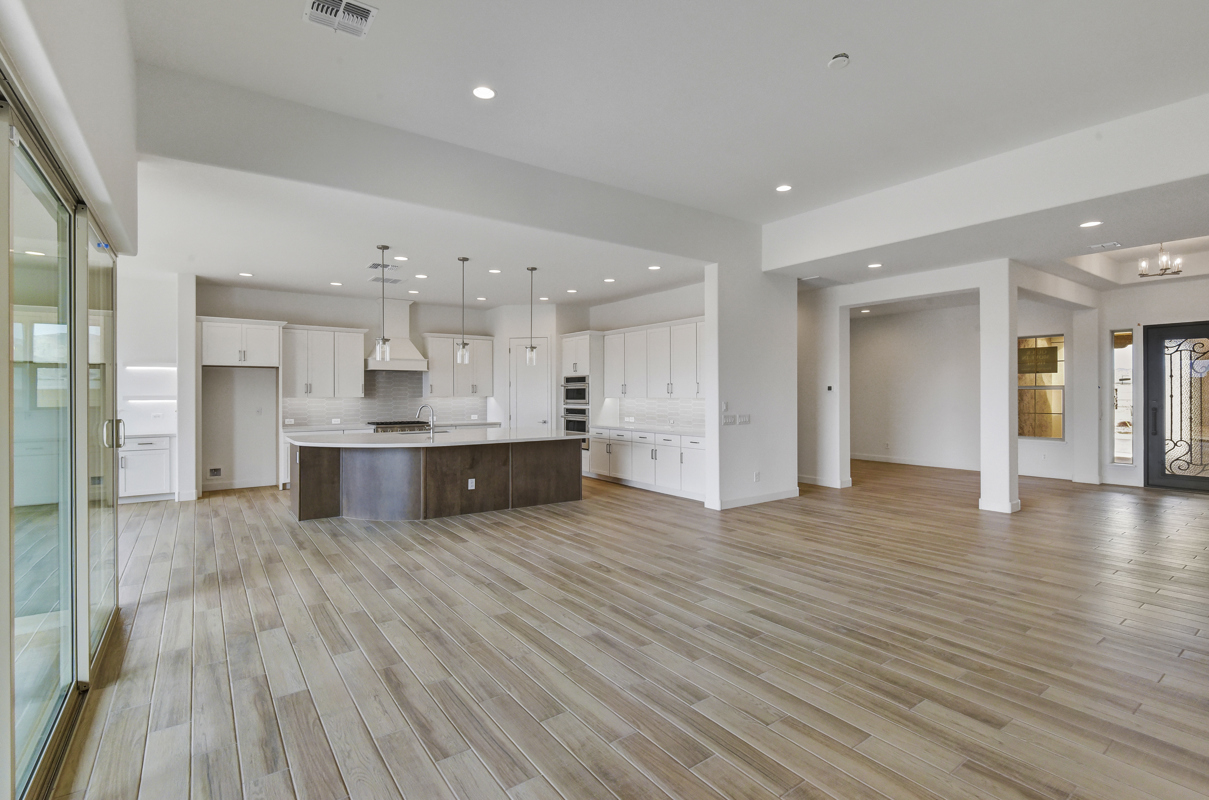 Spacious Family Room in New Construction Home in Litchfield Park, AZ - Featuring Open-Concept Design, High Ceilings, and Natural Light for Comfortable Living and Entertaining