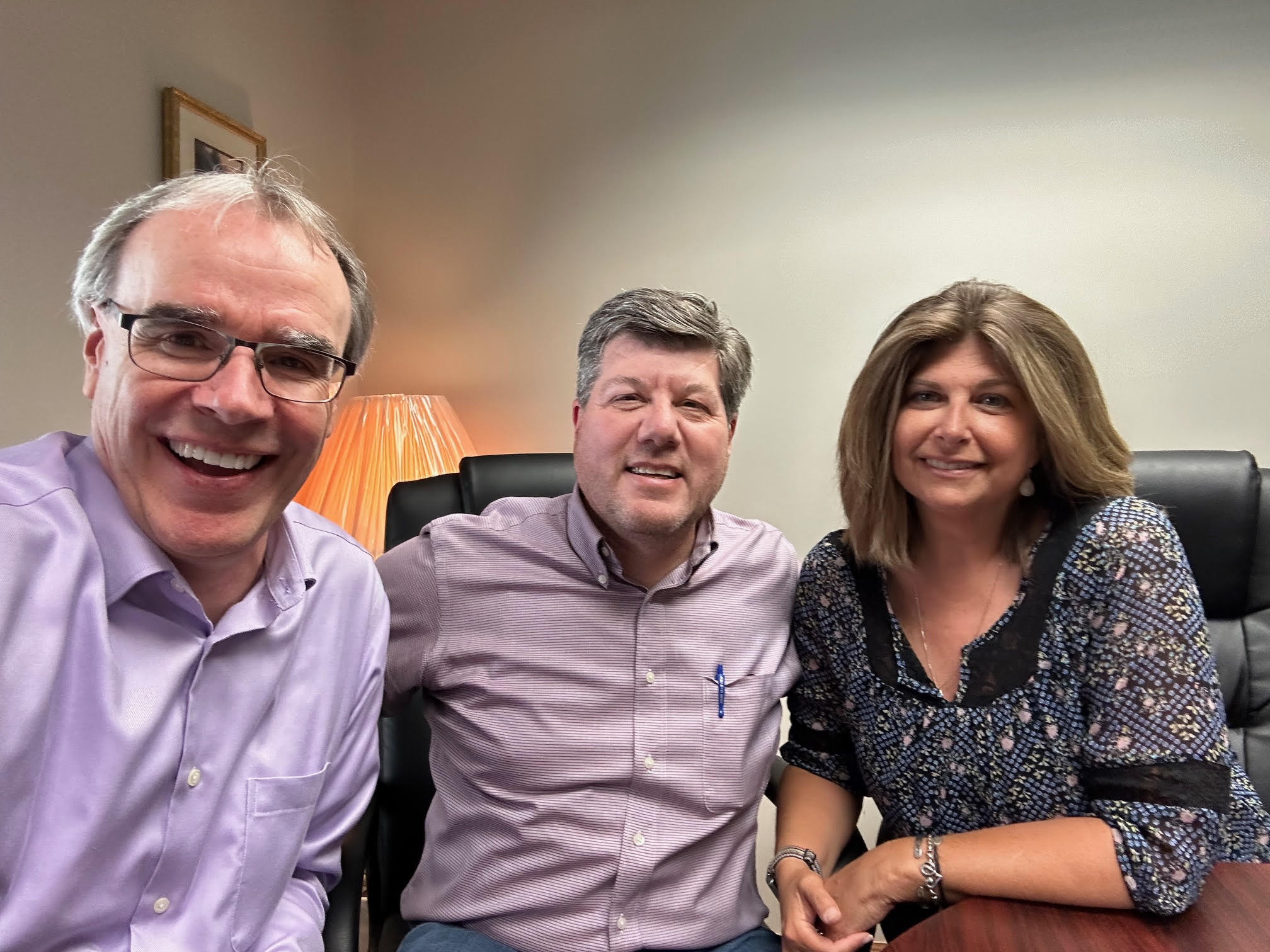 David Campbell smiling and posing next to a man and woman - both smiling at the camera as well.