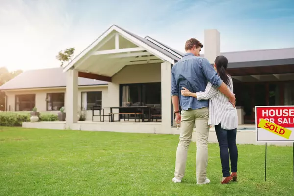 its-all-ours-shot-young-couple-admiring-their-newly-purchased-house