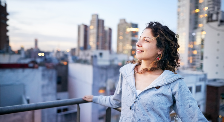 Person smiling with cityscape in background