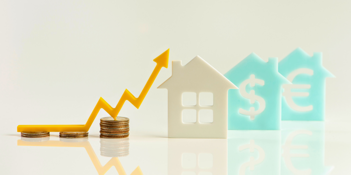 Visual representation of real estate wealth-building with a yellow upward arrow over stacked coins, symbolizing financial growth and opportunities in the 2025 Arizona housing market, as highlighted in the blog discussing passive income, property investments, and market trends.