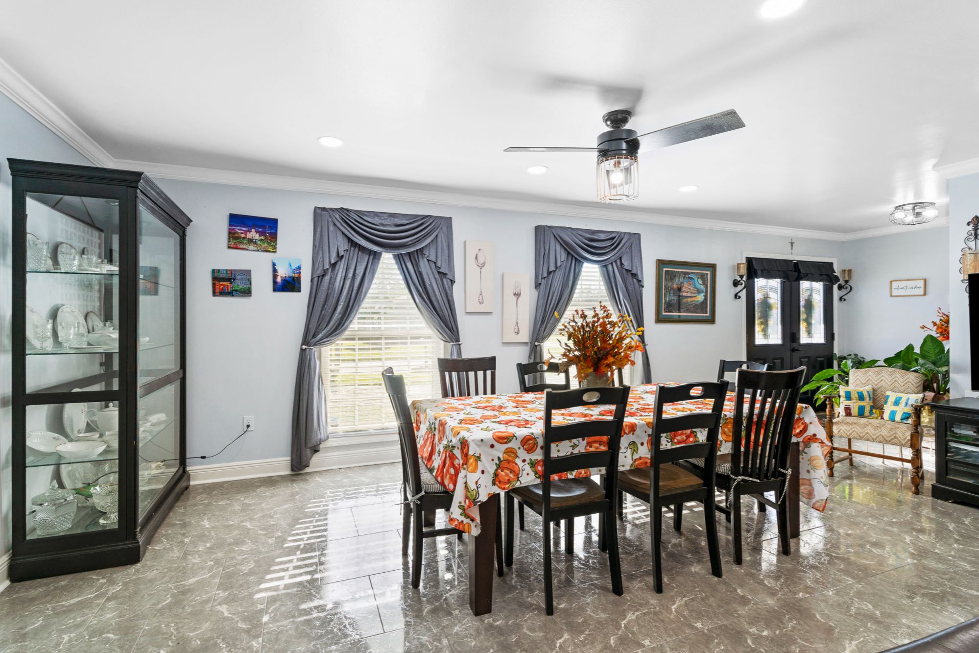 Spacious formal dining room at 408 Avenue A, Belle Chasse, LA, featuring a large dining table, natural light from the windows, and high-end tile floors