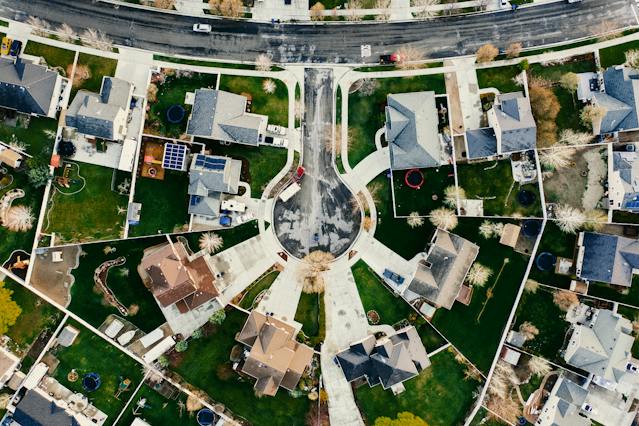 Aerial view of a suburban cul-de-sac with diverse house designs and well-kept lawns.