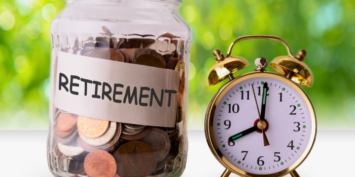 A jar labeled 'Retirement' filled with coins and an alarm clock, symbolizing the importance of saving and time management in retirement planning.