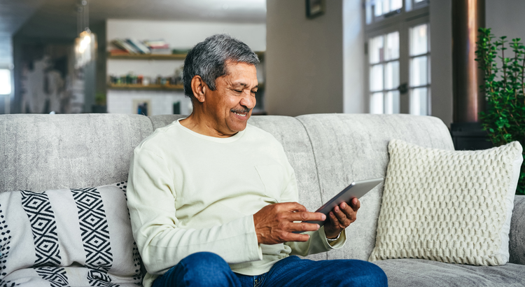 Person looking at tablet while sitting on couch