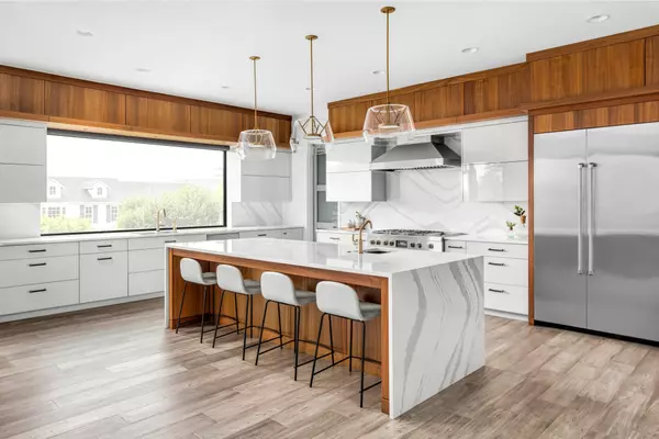 Beautiful kitchen in new luxury home with large waterfall island, gorgeous backsplash and cabinets. (3)