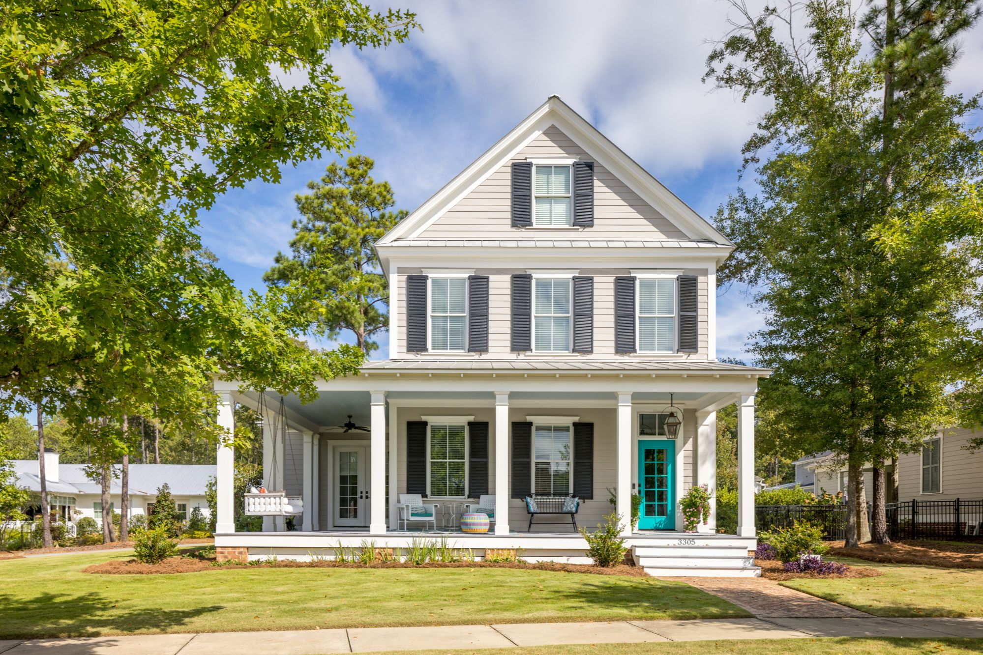 Single family home exterior front view in lucious greenscape