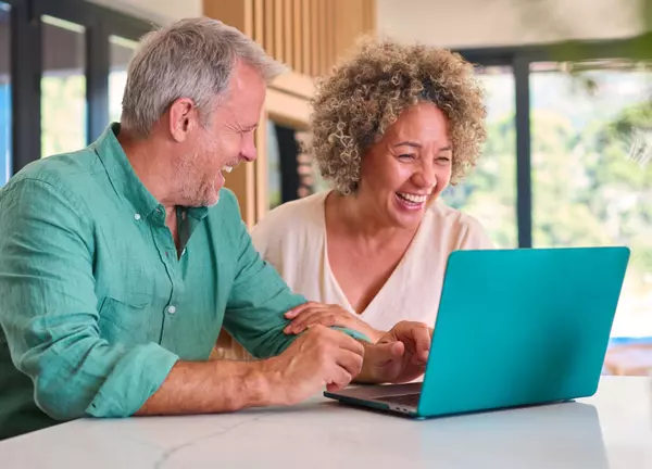 smiling-multi-racial-mature-couple-at-home-looking-2024-04-25-19-09-33-utc