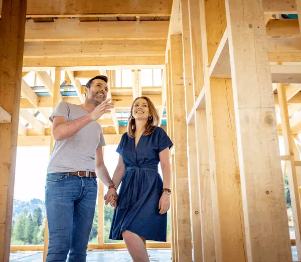 A married couple touring their new home construction during the building process