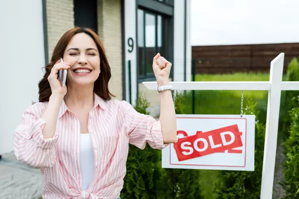 cheerful-woman-with-closed-eyes-gesturing-while-ta-2023-11-27-05-11-45-utc