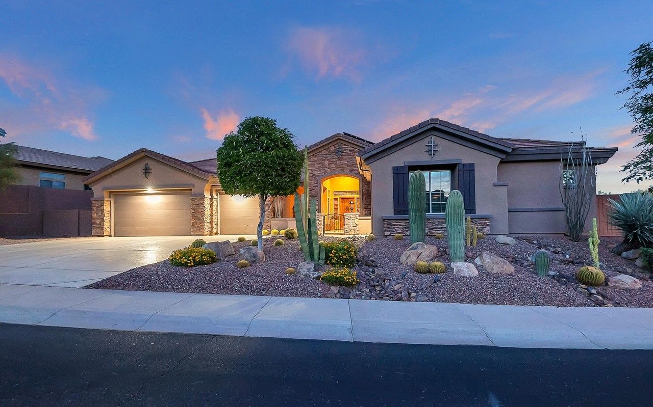 Beautiful single-story home in Anthem, Arizona, showcasing modern Southwestern architecture with desert landscaping, a spacious three-car garage, and charming stone accents. This home is an example of the luxury and comfort offered in Anthem's master-planned community, featuring family-friendly designs, energy-efficient features, and proximity to amenities like parks, hiking trails, and top-rated schools. Ideal for families, retirees, and outdoor enthusiasts seeking a peaceful yet vibrant lifestyle in the Phoenix area.