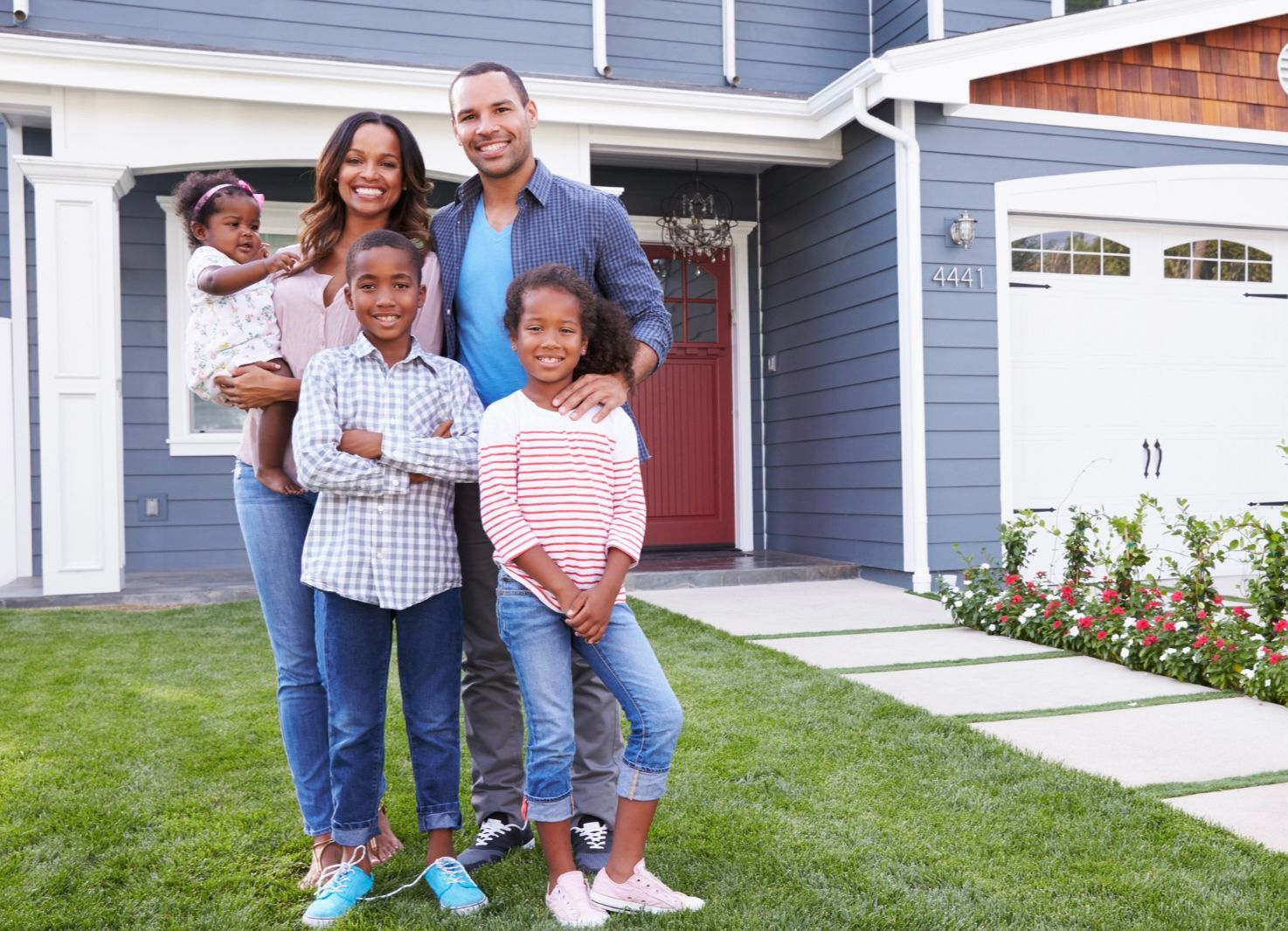 happy family in front of home
