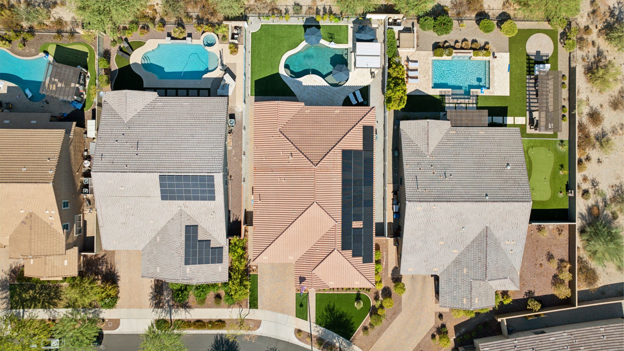 Aerial view of a luxury off-grid home in Verrado, AZ, highlighting its expansive lot, sparkling pool, and stunning desert surroundings with no neighbors behind, offering complete privacy and panoramic mountain views.